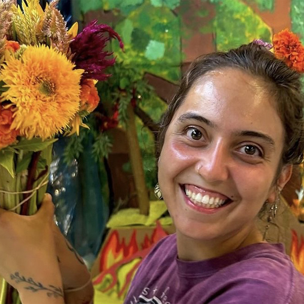 Gabriela Batista Oliveira with a handful of colorful blooms