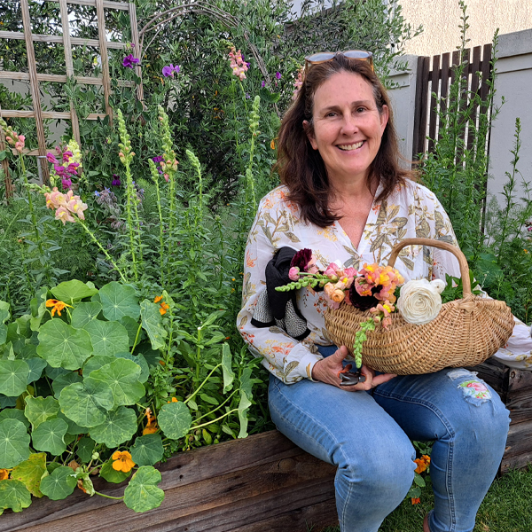 Sue Bellwood sitting in her garden