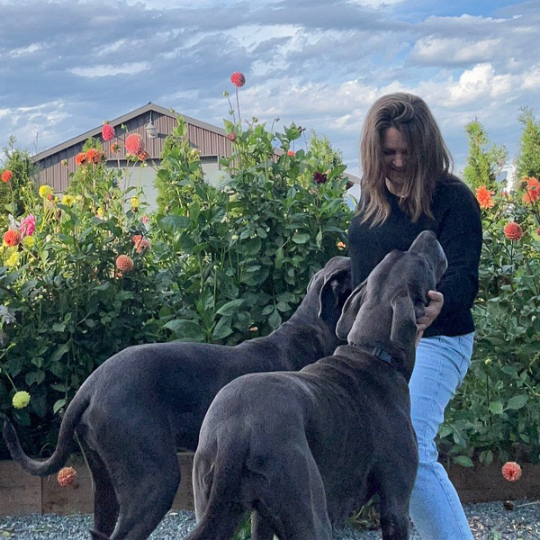 Crystalynn Binnendyk in her garden with her two dogs