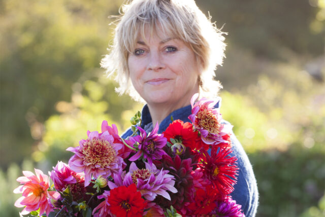 Sarah Raven holding a bouquet of flowers