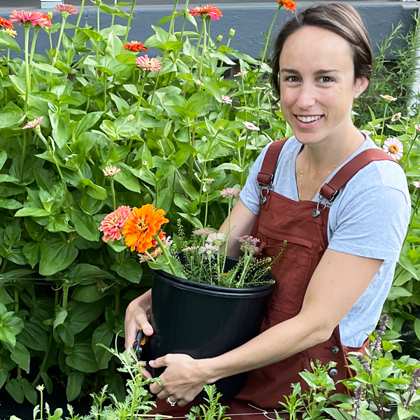 Angela Nieto holding bucket of flowers