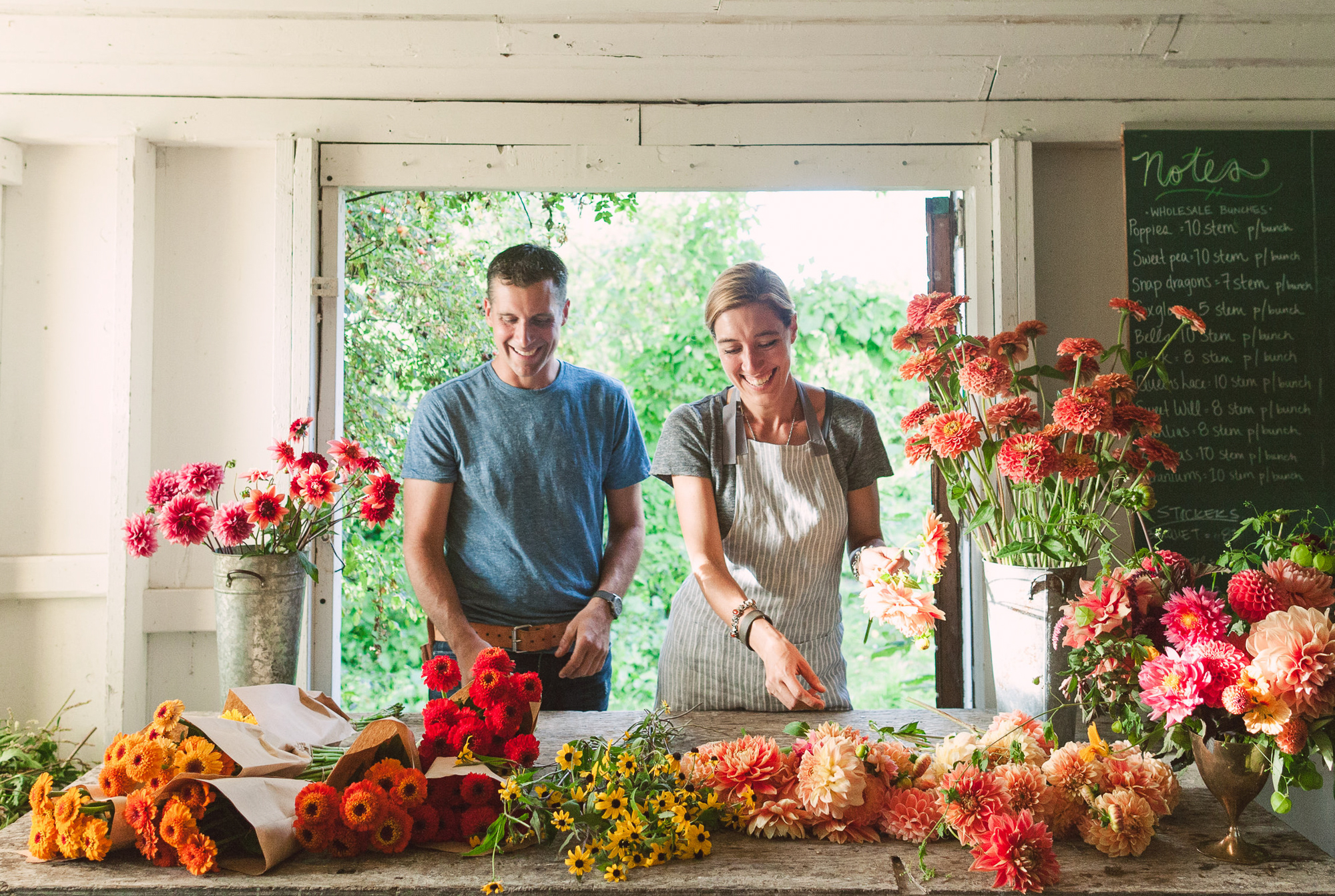 Erin and Chris Benzakein arranging flowers in the studio