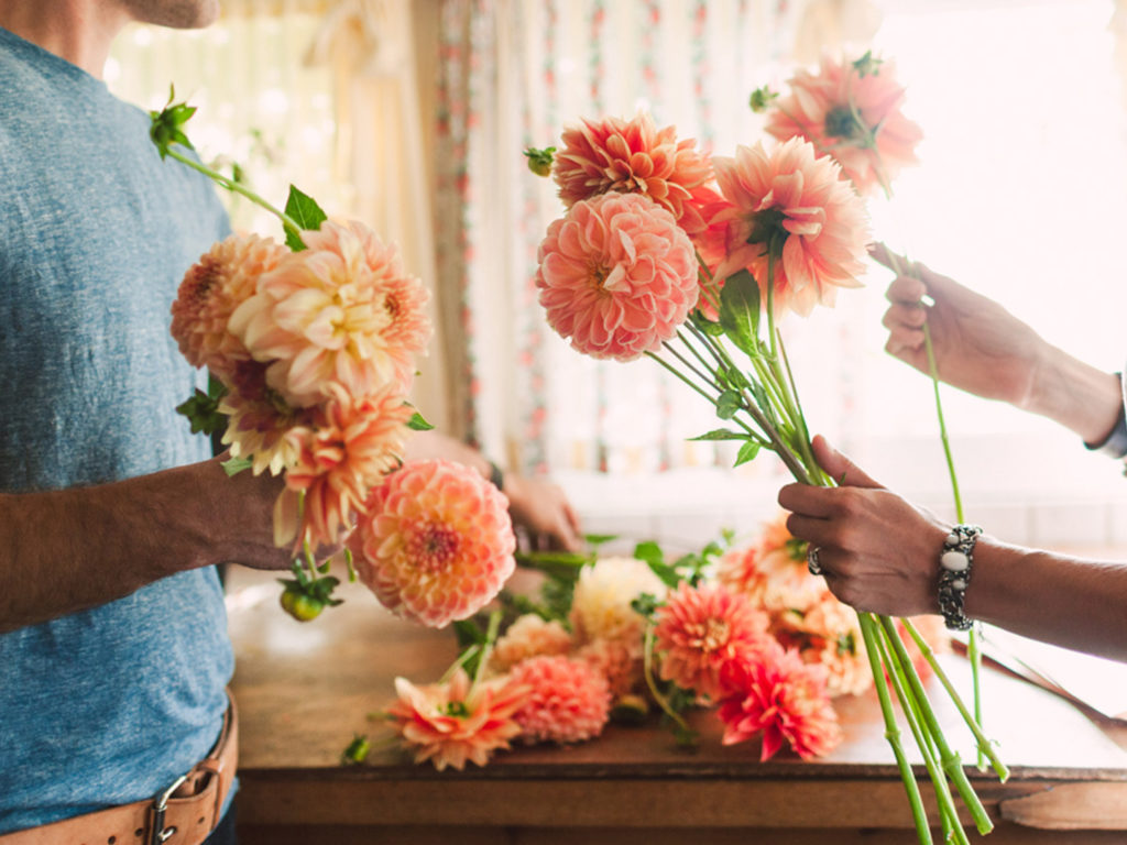 Erin and Chris Benzakein arranging dahlias in the Floret studio